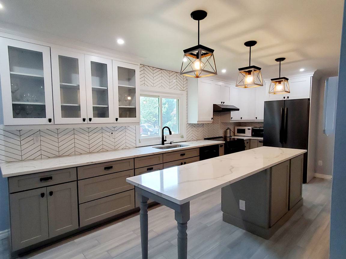 A kitchen design with white cabinets and grey counter tops