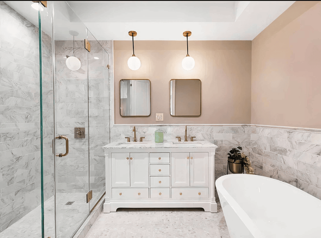 A luxurious Tampa bathroom remodel featuring a freestanding bathtub, earthy-toned tile, and modern fixtures. Perfect for spa-like relaxation