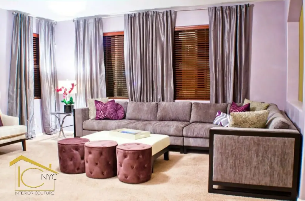 A residential interior design featuring a living room adorned with purple curtains and a comfortable couch.
